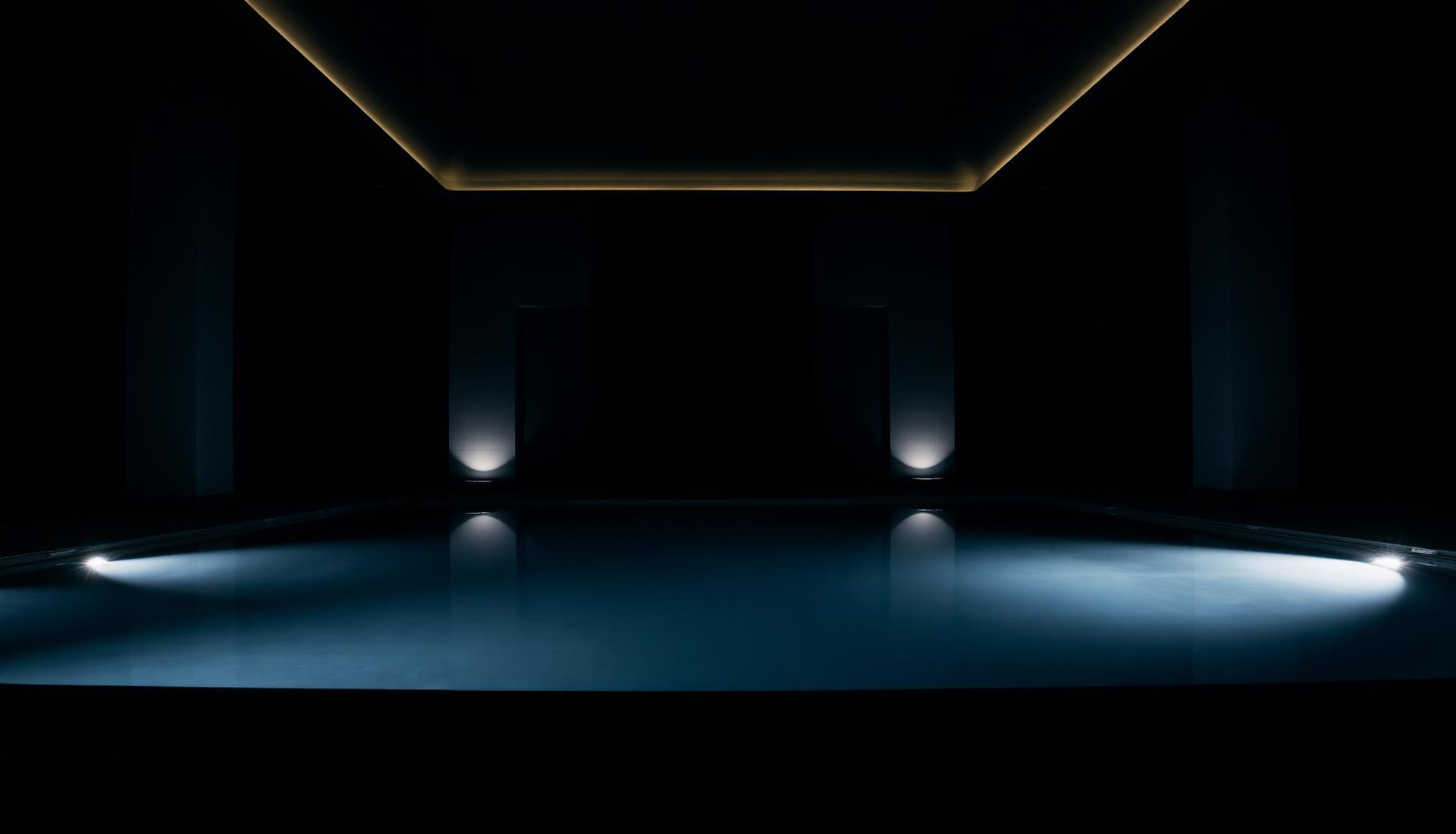 Moody luxury swimming pool at night